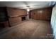 Living area with brick fireplace and wood paneling at 319 N Peterson St, Stanley, NC 28164