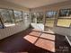 Sunroom with terracotta tile floor and windows offering a view of the backyard at 319 N Peterson St, Stanley, NC 28164