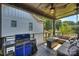 Covered back deck with a built-in grill and comfortable seating at 416 Wesley Heights Way, Charlotte, NC 28208