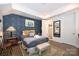Bedroom with blue brick accent wall and en-suite bathroom at 416 Wesley Heights Way, Charlotte, NC 28208
