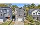 Modern gray home with a two-car garage, balconies, and a well-manicured lawn, perfect for urban living at 416 Wesley Heights Way, Charlotte, NC 28208