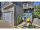 Modern home with light gray siding, blue door, and stone walkway at 416 Wesley Heights Way, Charlotte, NC 28208