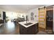 Open kitchen features a center island and yellow barn door at 416 Wesley Heights Way, Charlotte, NC 28208