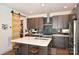 Modern kitchen with dark cabinets, white countertops, and an island at 416 Wesley Heights Way, Charlotte, NC 28208