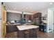 Modern kitchen with island, dark cabinets, and yellow sliding door at 416 Wesley Heights Way, Charlotte, NC 28208