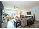 Open living room with sectional sofa and built-in shelving at 416 Wesley Heights Way, Charlotte, NC 28208