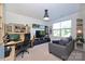 Home office with built-in shelving, a desk, and comfortable seating at 416 Wesley Heights Way, Charlotte, NC 28208