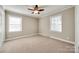 Well-lit bedroom featuring carpet, two windows, and a ceiling fan at 4193 Walker Rd, Rock Hill, SC 29730