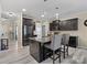 Modern kitchen features dark cabinetry, stainless steel appliances, granite countertops, and an island with bar seating at 490 Melvista Ave, Rock Hill, SC 29732