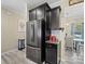 Well-equipped kitchen features stainless steel fridge, dark cabinets, and adjacent dining area at 490 Melvista Ave, Rock Hill, SC 29732