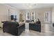 Bright living room with two black sofas, natural lighting, modern decor and stylish area rug at 490 Melvista Ave, Rock Hill, SC 29732