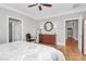 Main bedroom with hardwood floors, dresser, and access to other rooms at 535 Chalmers Row, Rock Hill, SC 29732