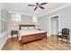 Spacious bedroom with hardwood floors, ceiling fan, and large windows at 535 Chalmers Row, Rock Hill, SC 29732