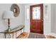 Inviting entryway with hardwood floors, glass-top console table, and stained glass door at 535 Chalmers Row, Rock Hill, SC 29732