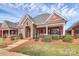 Attractive brick home featuring stone accents, covered porch, landscaped front yard and symmetrical design at 535 Chalmers Row, Rock Hill, SC 29732