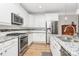 Beautiful kitchen with stainless steel appliances, granite countertops, white cabinets, and a modern tiled backsplash at 535 Chalmers Row, Rock Hill, SC 29732