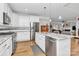 Bright kitchen with stainless steel appliances, white cabinetry, granite countertops, and a central island with pendant lighting at 535 Chalmers Row, Rock Hill, SC 29732