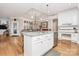 Open kitchen featuring a granite island with seating, stainless steel appliances, hardwood floors, and white cabinetry at 535 Chalmers Row, Rock Hill, SC 29732
