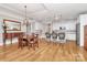 Dining area featuring hardwood floors, a chandelier, and a spacious kitchen with stainless steel appliances and a large island at 535 Chalmers Row, Rock Hill, SC 29732