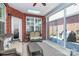 Inviting sunroom with brick walls, skylight, ceiling fan, large windows with shutters, and comfortable wicker furniture at 535 Chalmers Row, Rock Hill, SC 29732