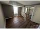 Small bedroom with laminate wood floors and access to a closet at 9401 Old Concord Rd # K, Charlotte, NC 28213