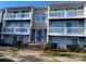 Two-story building exterior with blue door and multiple balconies at 9401 Old Concord Rd # K, Charlotte, NC 28213