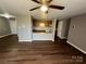 Living room with laminate floors and kitchen passthrough at 9401 Old Concord Rd # K, Charlotte, NC 28213