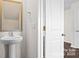 Small half bathroom with pedestal sink and mirror at 1029 20Th Avenue Se Loop, Hickory, NC 28602