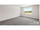 Bright bedroom with a large window and neutral carpeting at 1029 20Th Avenue Se Loop, Hickory, NC 28602