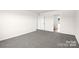 Primary bedroom with gray carpeting and access to the bathroom at 1029 20Th Avenue Se Loop, Hickory, NC 28602