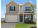 Two-story house with beige vinyl siding, a two-car garage, and landscaping at 1029 20Th Avenue Se Loop, Hickory, NC 28602