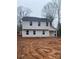 Two-story house with gray vinyl siding, showcasing a simple yet modern design at 104 Springdale St, Shelby, NC 28150