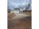 Charming two-story home with a spacious driveway and attached two-car garage on an overcast day at 104 Springdale St, Shelby, NC 28150