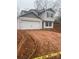 Two-story house with gray siding, attached garage, and a newly landscaped yard at 104 Springdale St, Shelby, NC 28150