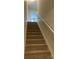 Carpeted staircase with a simple, modern railing leading upstairs at 104 Springdale St, Shelby, NC 28150