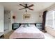 Spacious bedroom with a king-size bed and ceiling fan at 12548 Hennigan Place Ln, Charlotte, NC 28214