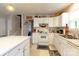 Kitchen with white cabinets and view of stairs at 12548 Hennigan Place Ln, Charlotte, NC 28214