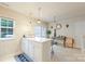 Kitchen features white cabinets and breakfast bar at 12548 Hennigan Place Ln, Charlotte, NC 28214