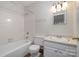 Bathroom featuring a vanity, toilet, and a tub with tile surround at 133 Orchard Trace Ln # 7, Charlotte, NC 28213