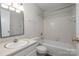 Bright bathroom featuring a vanity, toilet, and a tub with tile surround at 133 Orchard Trace Ln # 7, Charlotte, NC 28213