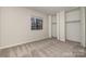 Cozy bedroom featuring plush carpeting, bright window, and ample closet space at 133 Orchard Trace Ln # 7, Charlotte, NC 28213