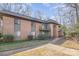Brick exterior with a sidewalk leading to units and trees surrounding the property at 133 Orchard Trace Ln # 7, Charlotte, NC 28213