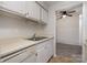 Galley kitchen featuring white appliances and cabinets, with a view into the living room at 133 Orchard Trace Ln # 7, Charlotte, NC 28213