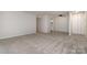 Spacious living room featuring carpeted floors and a ceiling fan at 133 Orchard Trace Ln # 7, Charlotte, NC 28213