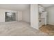 Open-concept living space with carpet, combined with a galley kitchen featuring appliances and a sliding glass door at 133 Orchard Trace Ln # 7, Charlotte, NC 28213