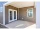 Covered patio with double doors, providing outdoor living space at 242 White Apple Way, Statesville, NC 28625