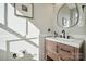 Modern bathroom with a floating vanity and a sleek, oval mirror at 330 Simeon Dr, Charlotte, NC 28208