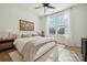 Main bedroom features a comfortable bed, a ceiling fan, and large windows at 330 Simeon Dr, Charlotte, NC 28208
