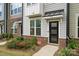 Modern townhouse exterior with landscaping and black door at 330 Simeon Dr, Charlotte, NC 28208