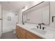 Bathroom features a marble tiled shower and a modern vanity with double sinks and light wood cabinets at 3415 Waxhaw Indian Trail S Rd, Waxhaw, NC 28173